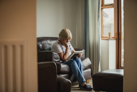 Woman mourning and looking at photograph