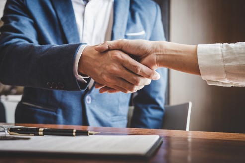 injury lawyer and client shaking hands
